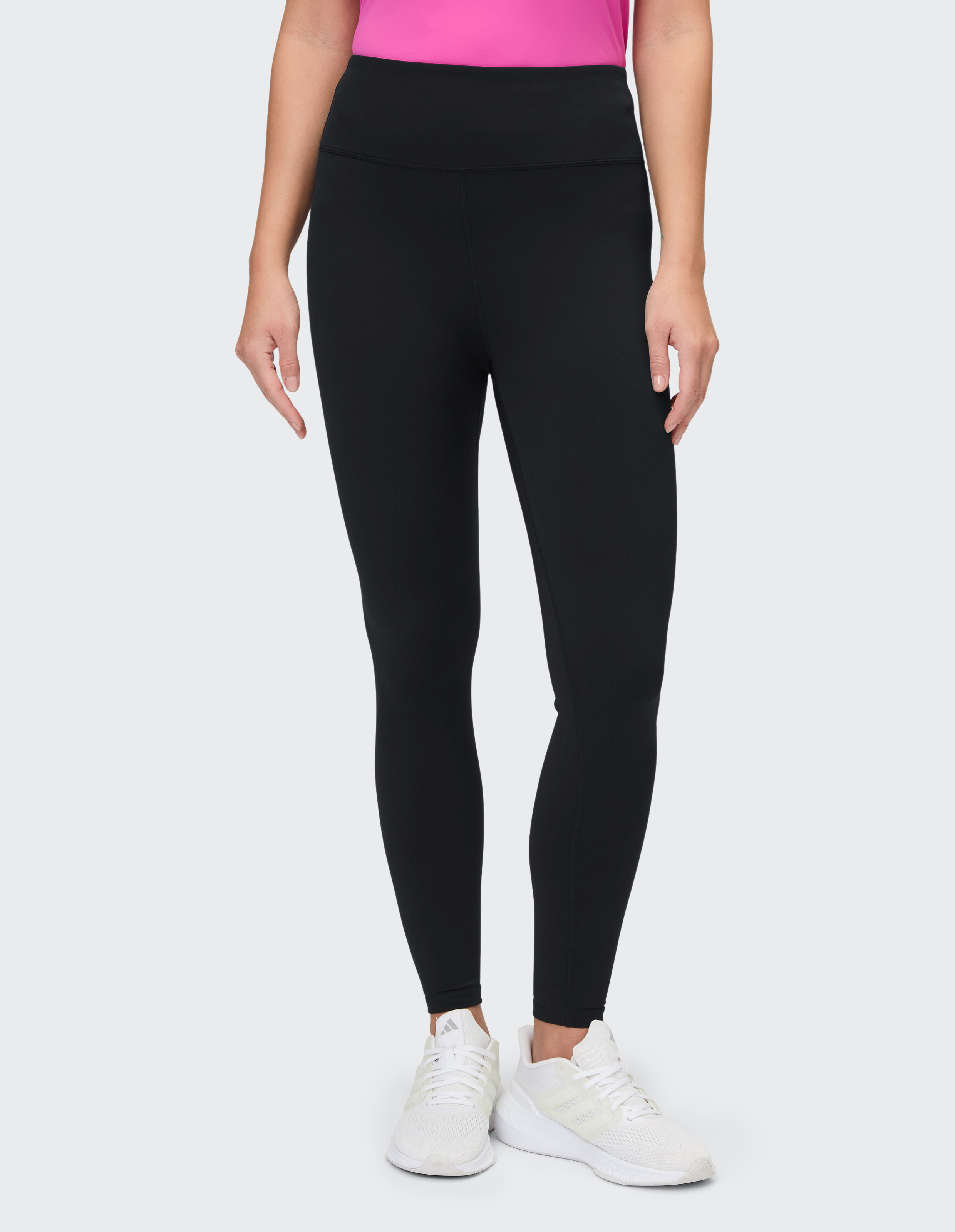 Frau trägt schwarze Leggings mit hoher Taille, perfekt zum entspannten Faulenzen oder für aktive Reisen.