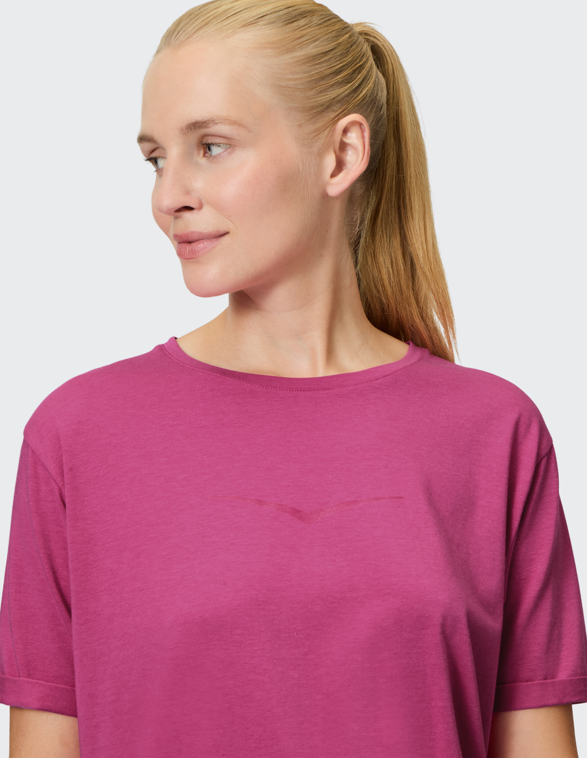 Frau trägt ein locker sitzendes rosa T-Shirt, perfekt für Freizeitausflüge.