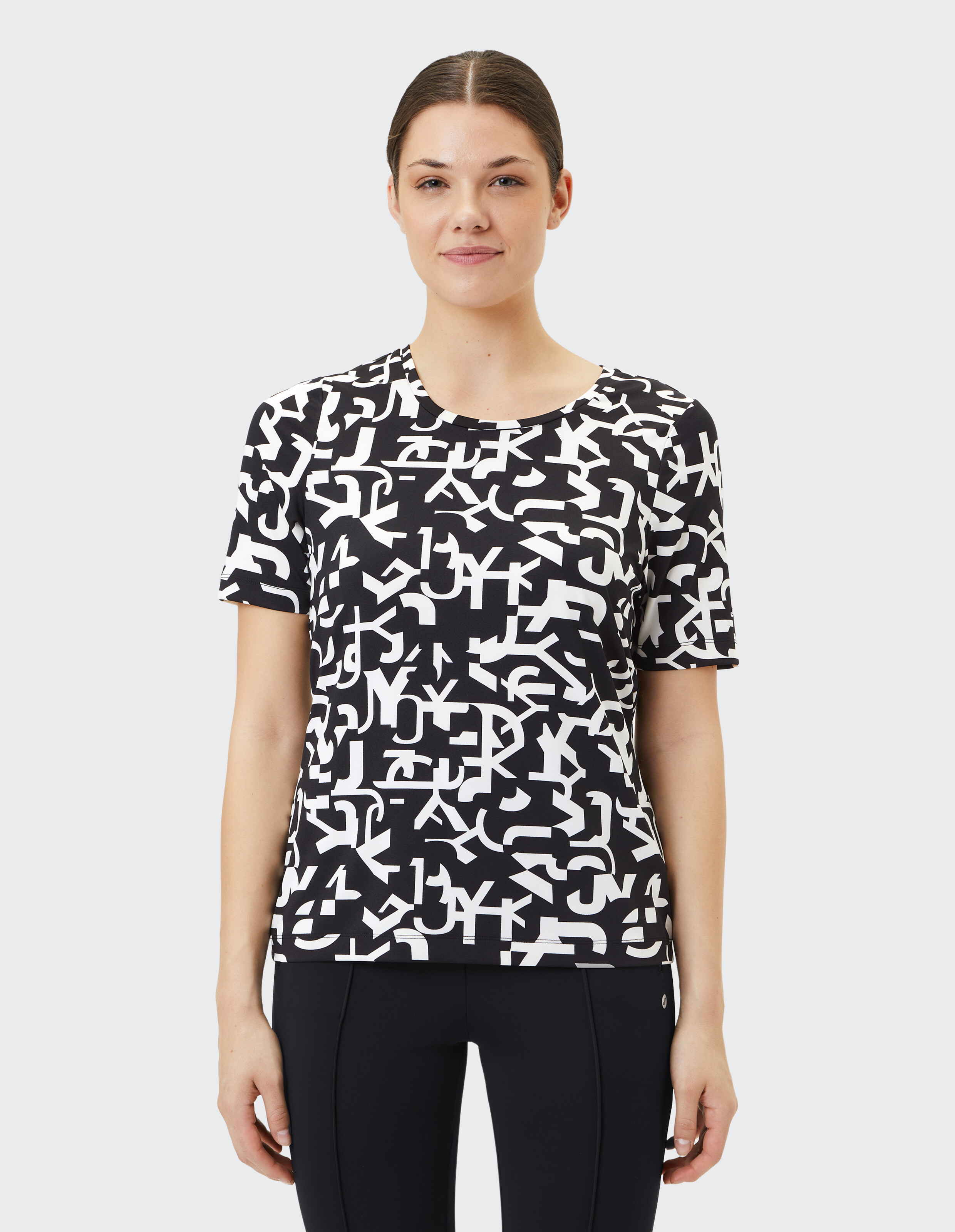 Das Model trägt ein schwarz-weißes Grafik-T-Shirt, perfekt für Freizeitausflüge.