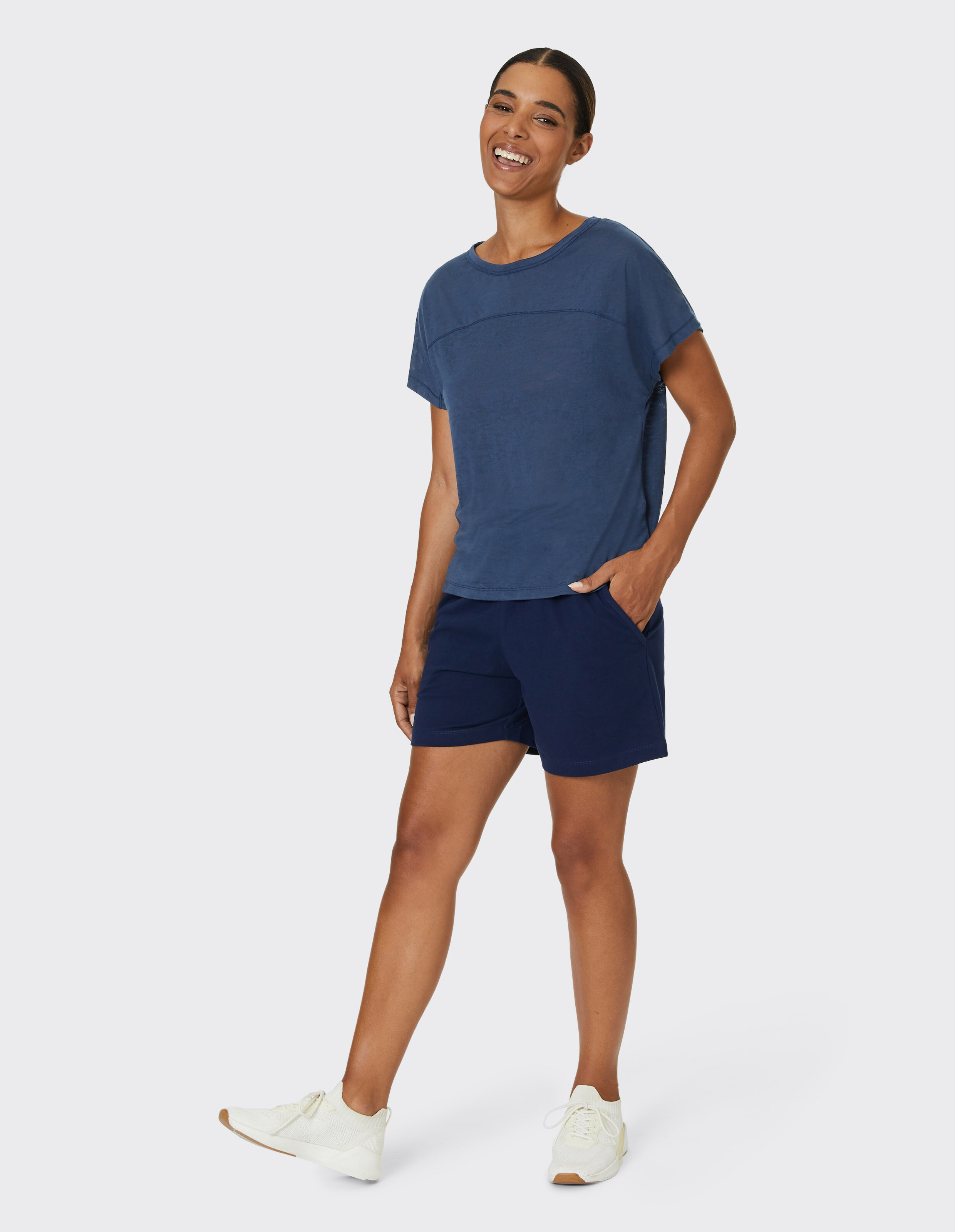 Frau in marineblauem Freizeit-Top und Shorts, perfekt zum Faulenzen oder Brunch.