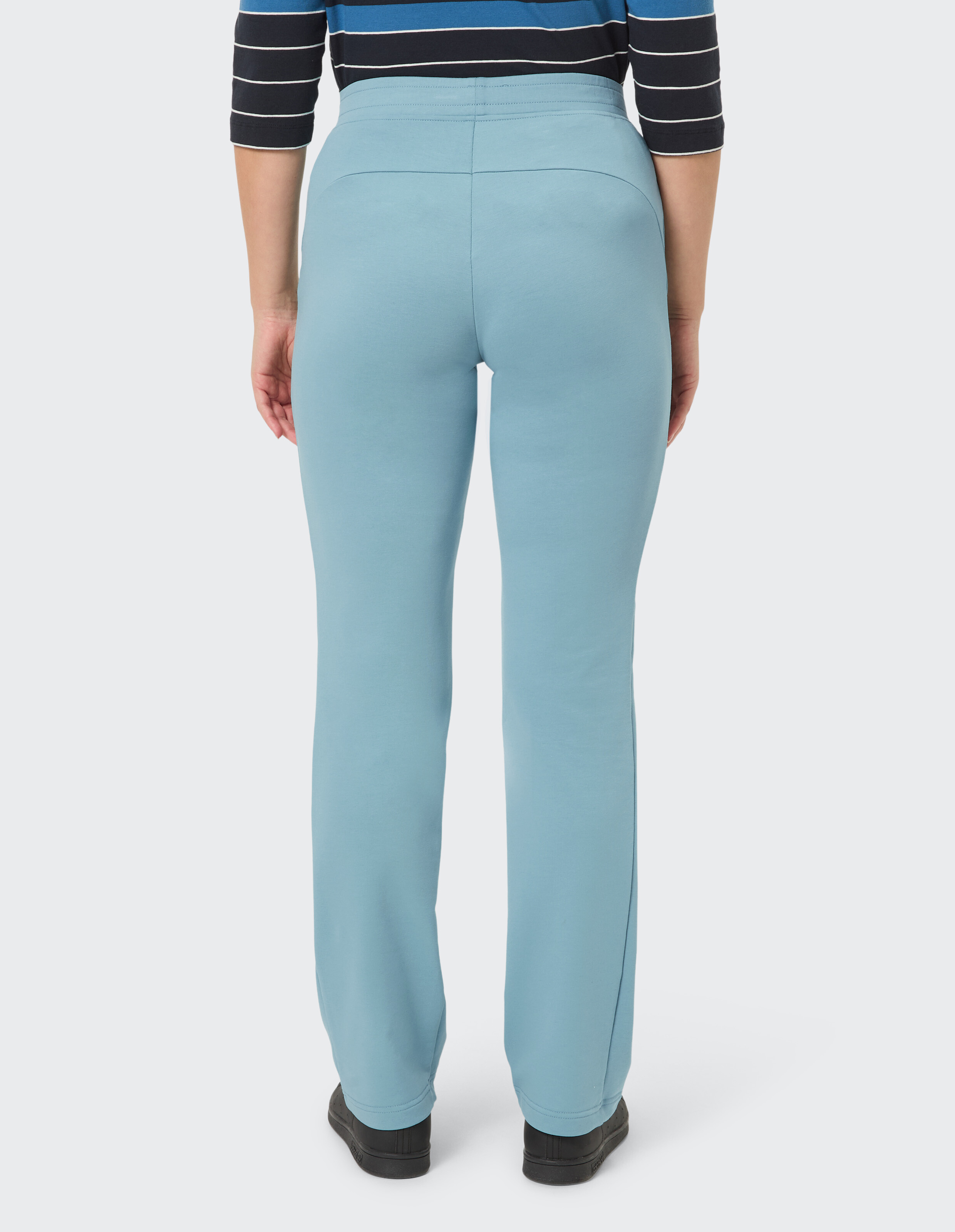 Rückansicht einer Frau in hellblauer Freizeithose mit bequemer Passform.