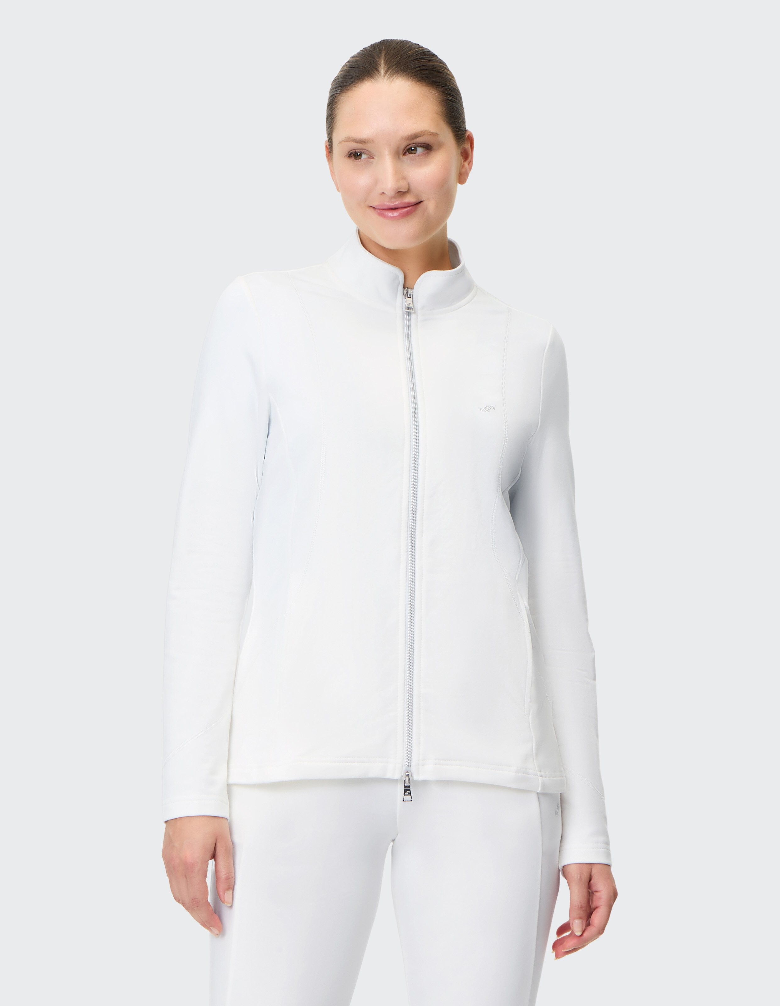 Frau trägt eine weiße Freizeitjacke mit Reißverschluss für bequeme Loungewear.