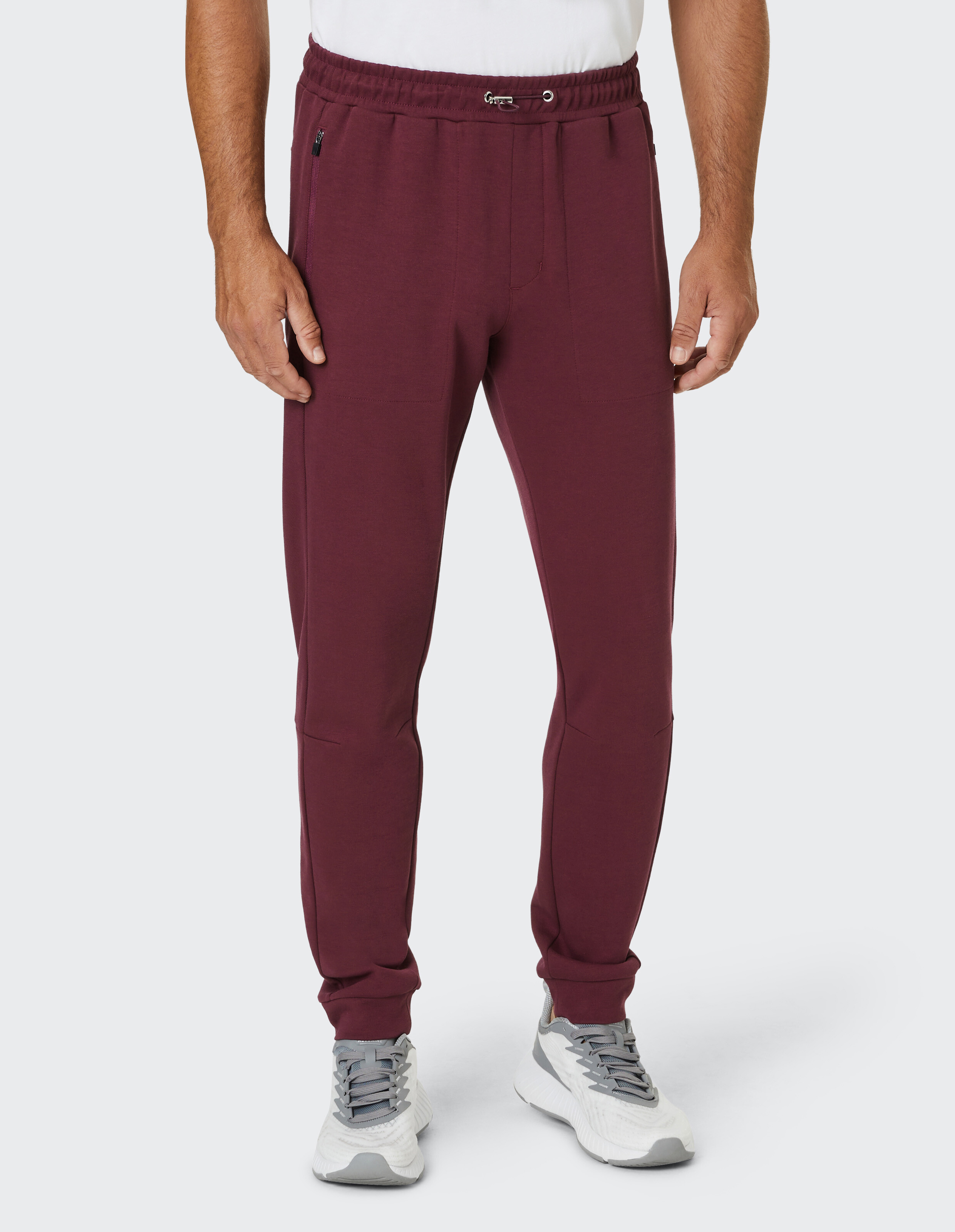 Bordeauxrote Jogginghose mit elastischem Bund und Kordelzug, schmalem Schnitt und geripptem Abschluss an den Knöcheln.