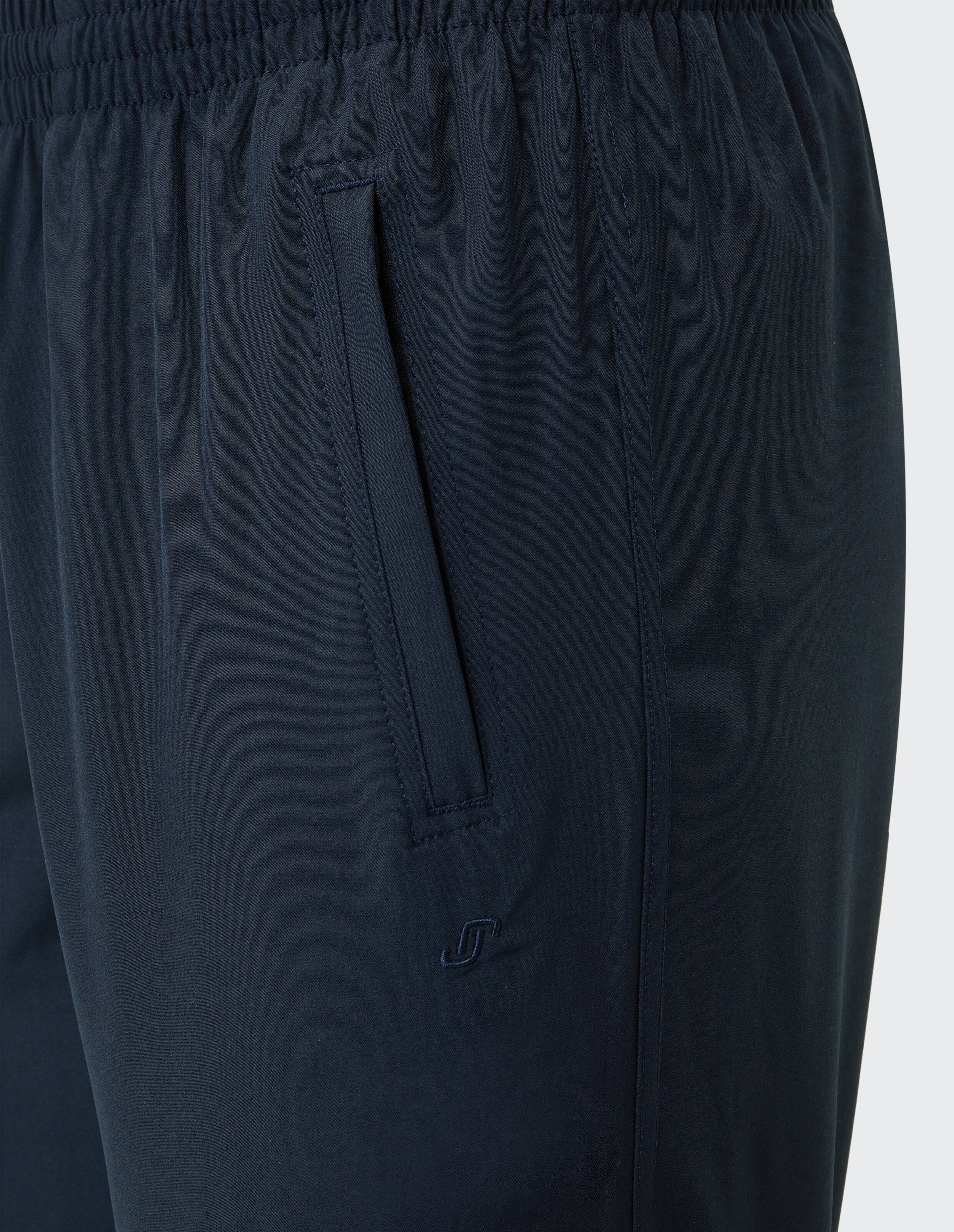 Dunkelblaue Jogginghose mit elastischem Bund, seitlicher Tasche und kleinem Logo auf Oberschenkel.