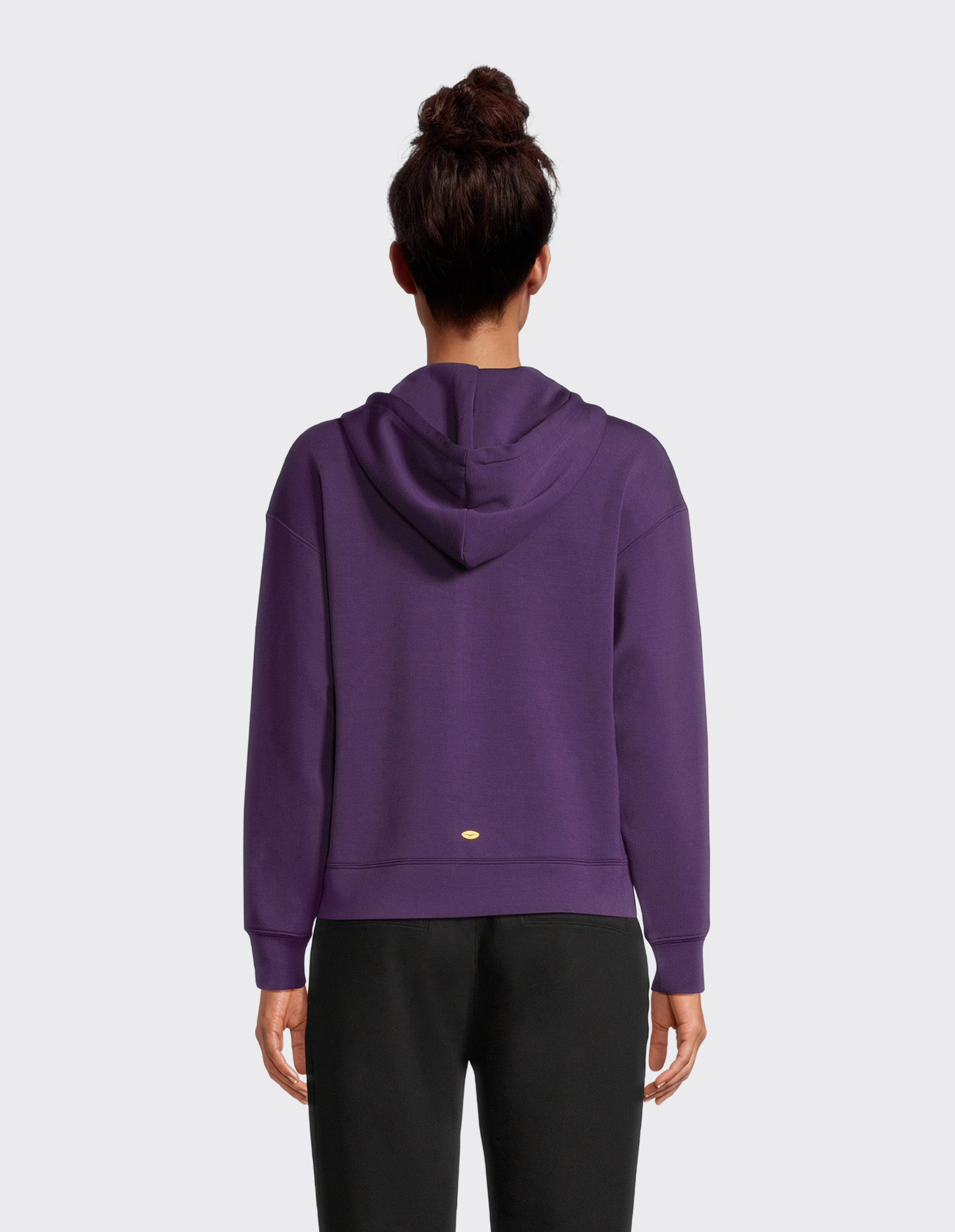 Rückansicht einer Frau, die einen lila Kapuzenpullover trägt, perfekt für Freizeitkleidung.