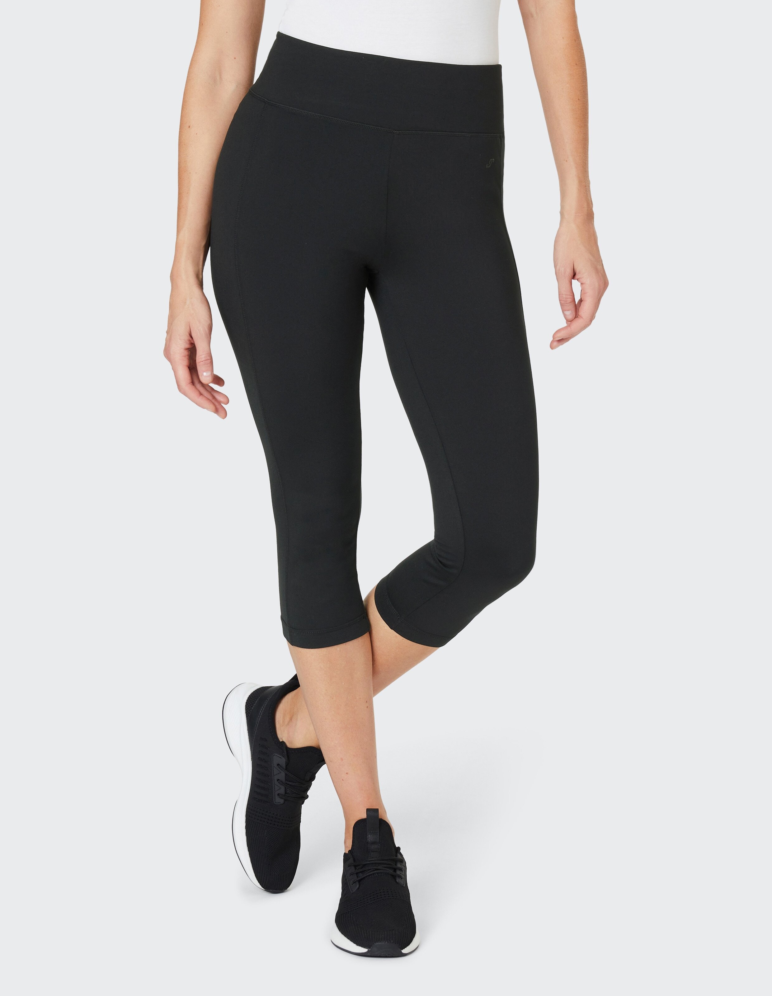 Schwarze dreiviertel Fitness-Leggings mit breitem Bund und nahtloser Optik, geeignet für Sport und Freizeitaktivitäten.