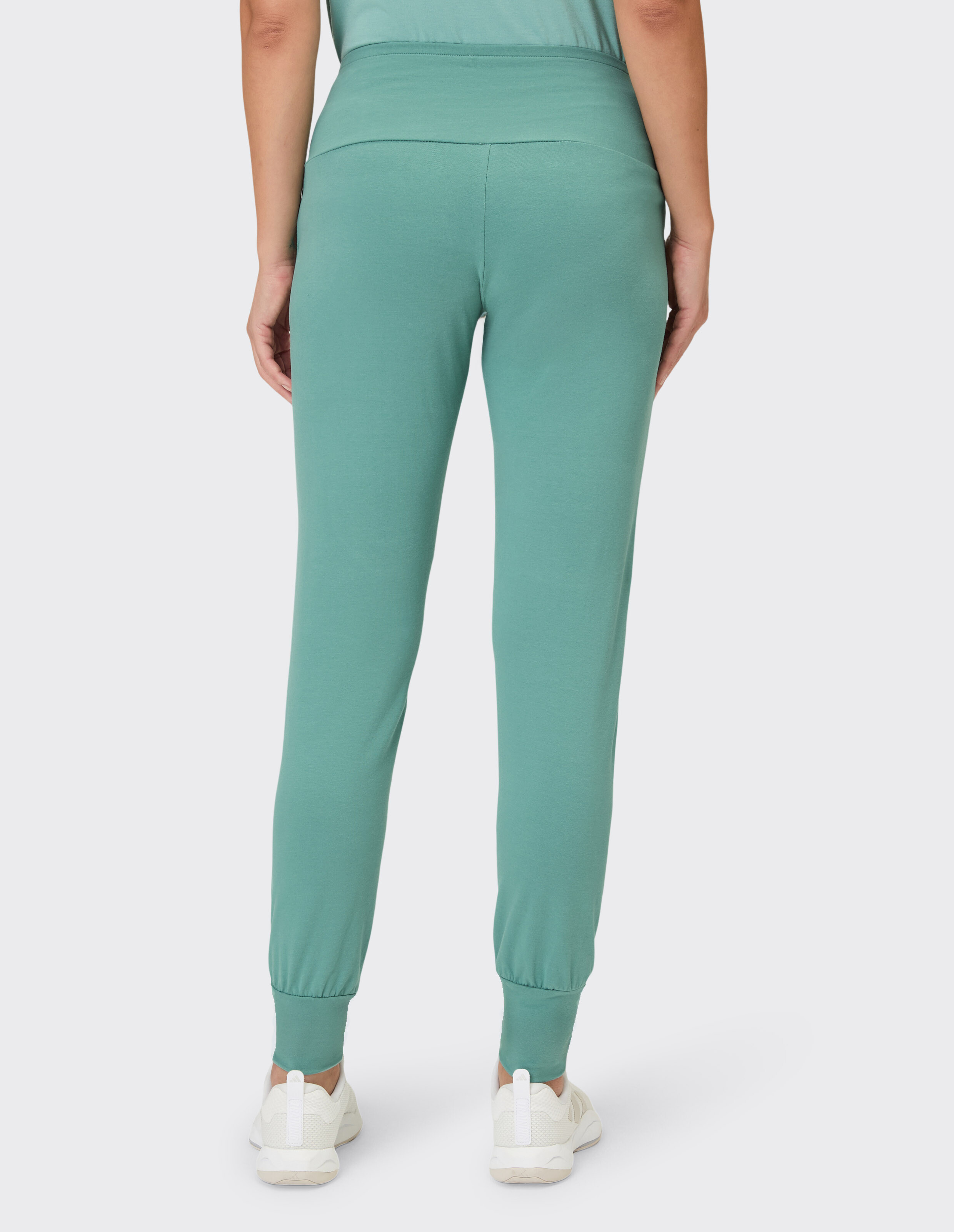 Rückansicht einer mintgrünen Jogginghose mit elastischen Bündchen, perfekt für Freizeitkleidung.