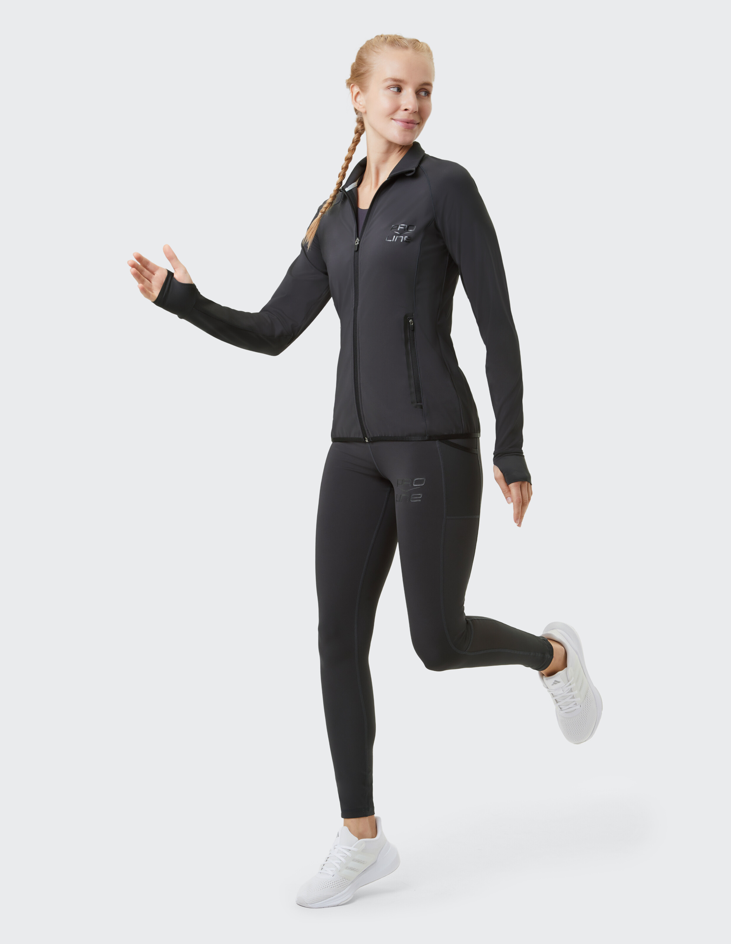 Frau trägt eine schwarze Venice Beach Funktionsjacke Hampton und passende Leggings.