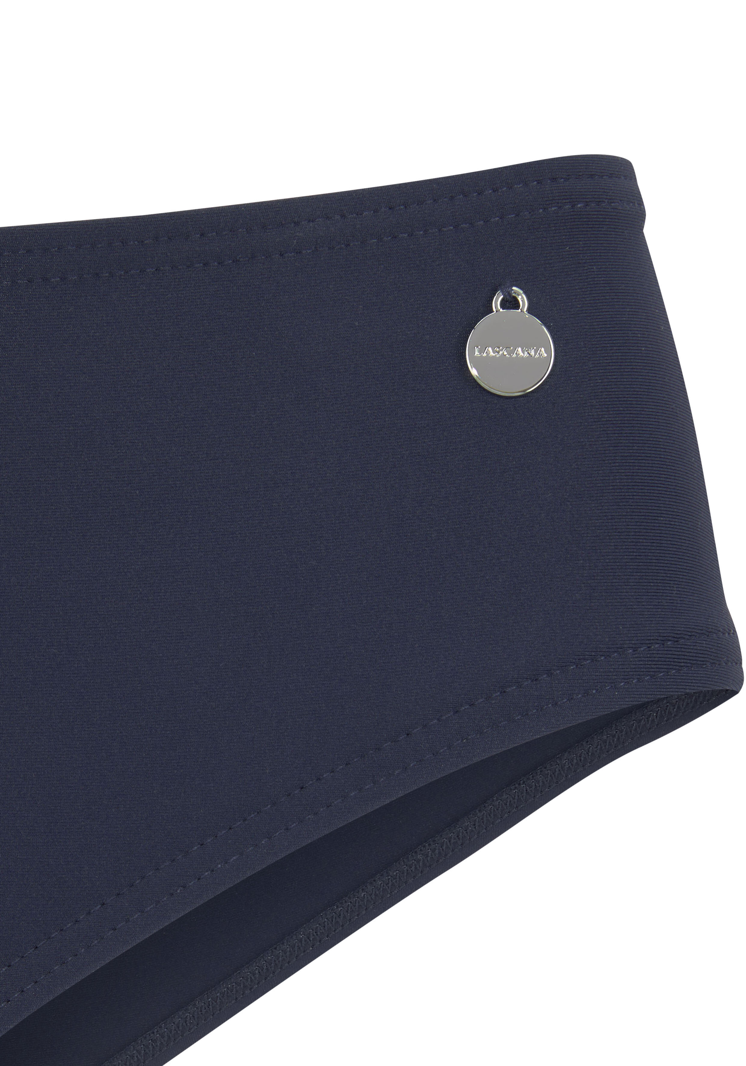 Nahaufnahme einer marineblauen Bikini-Hose Cassy mit einem kleinen silbernen Logo-Anhänger.