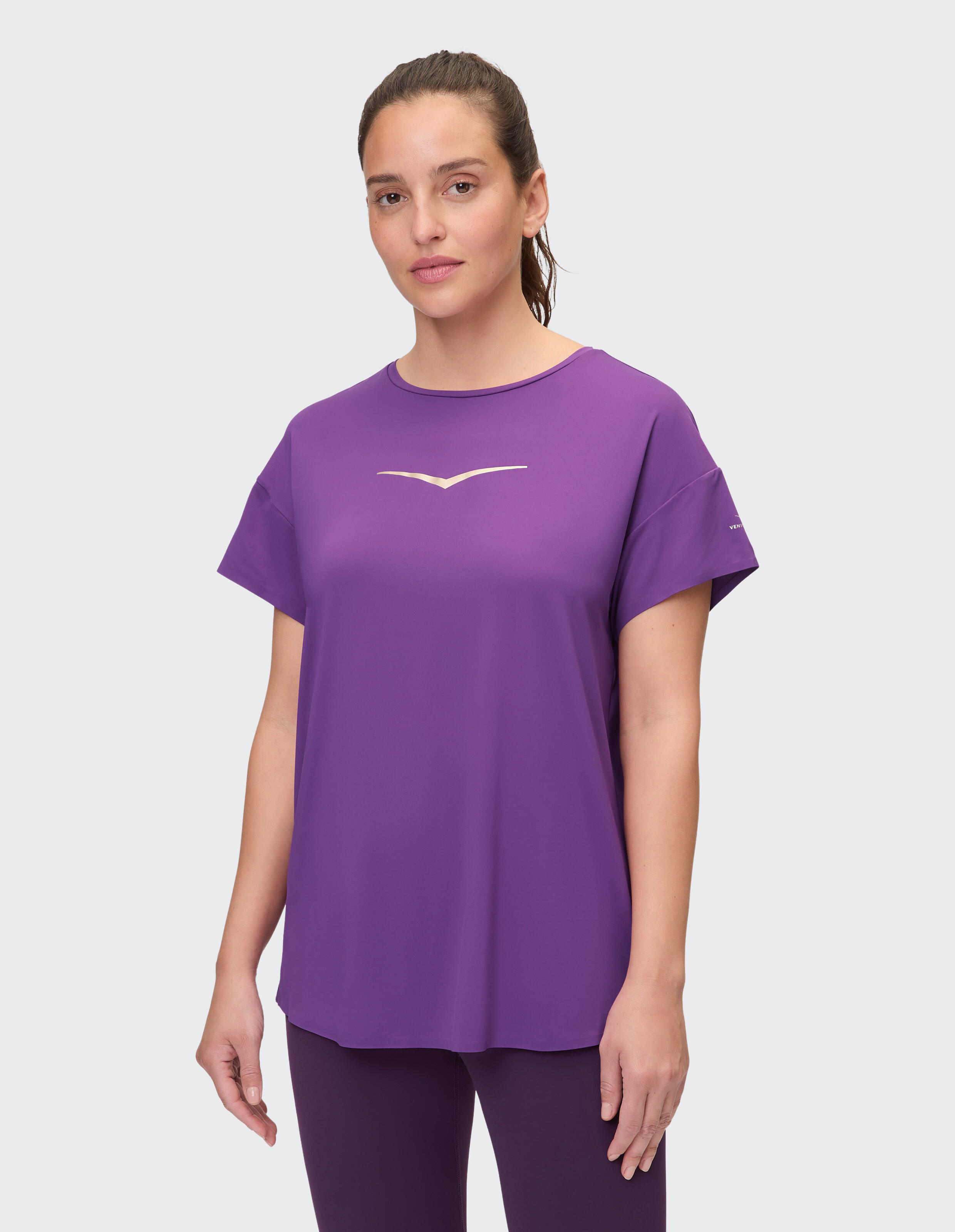 Frau in einem lilafarbenen, lässigen T-Shirt mit stilvollem Design, perfekt zum Entspannen.