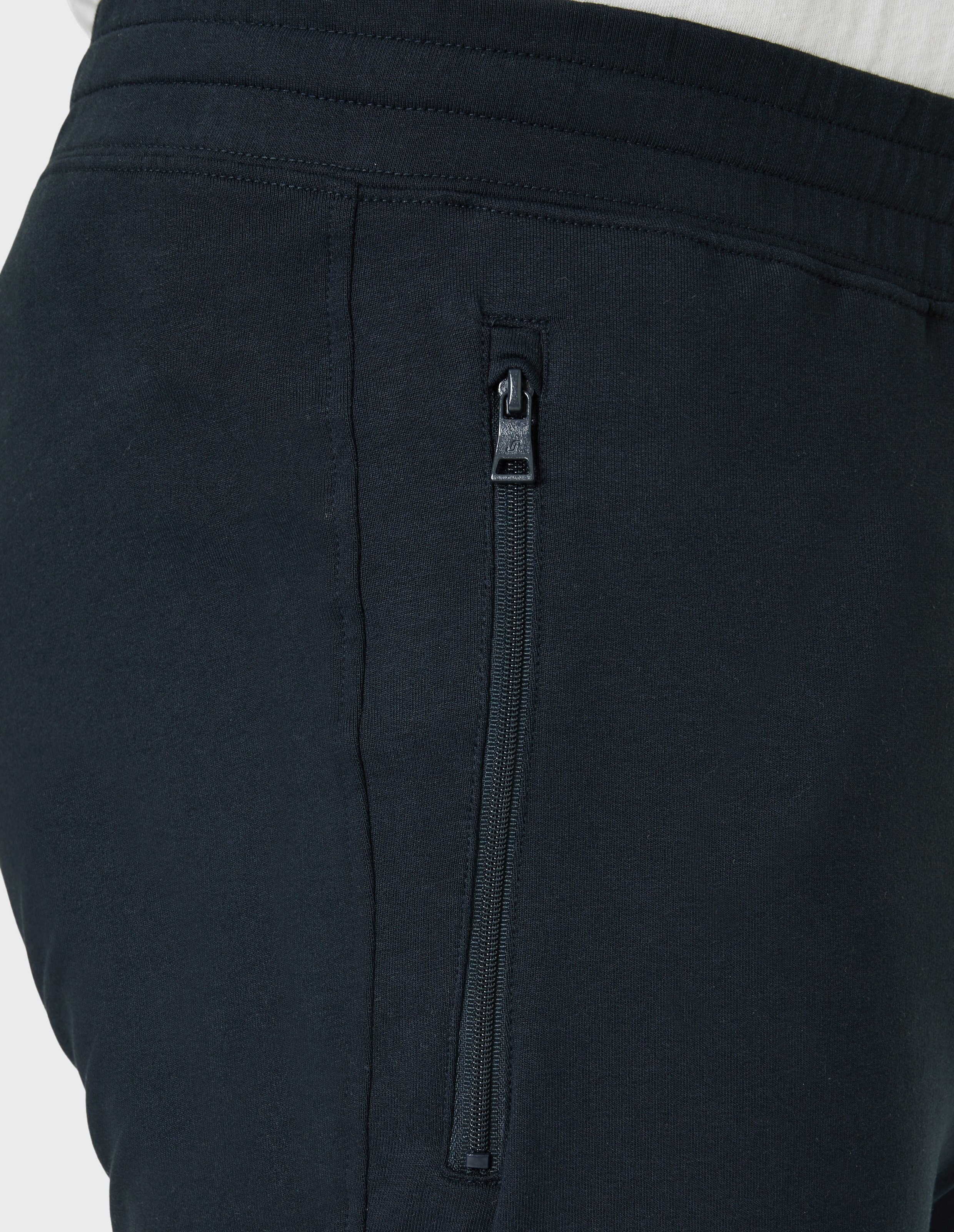 Dunkelblaue Jogginghose mit elastischem Bund, geradem Schnitt und minimalistischen Design, ideal für Freizeit und Sport.