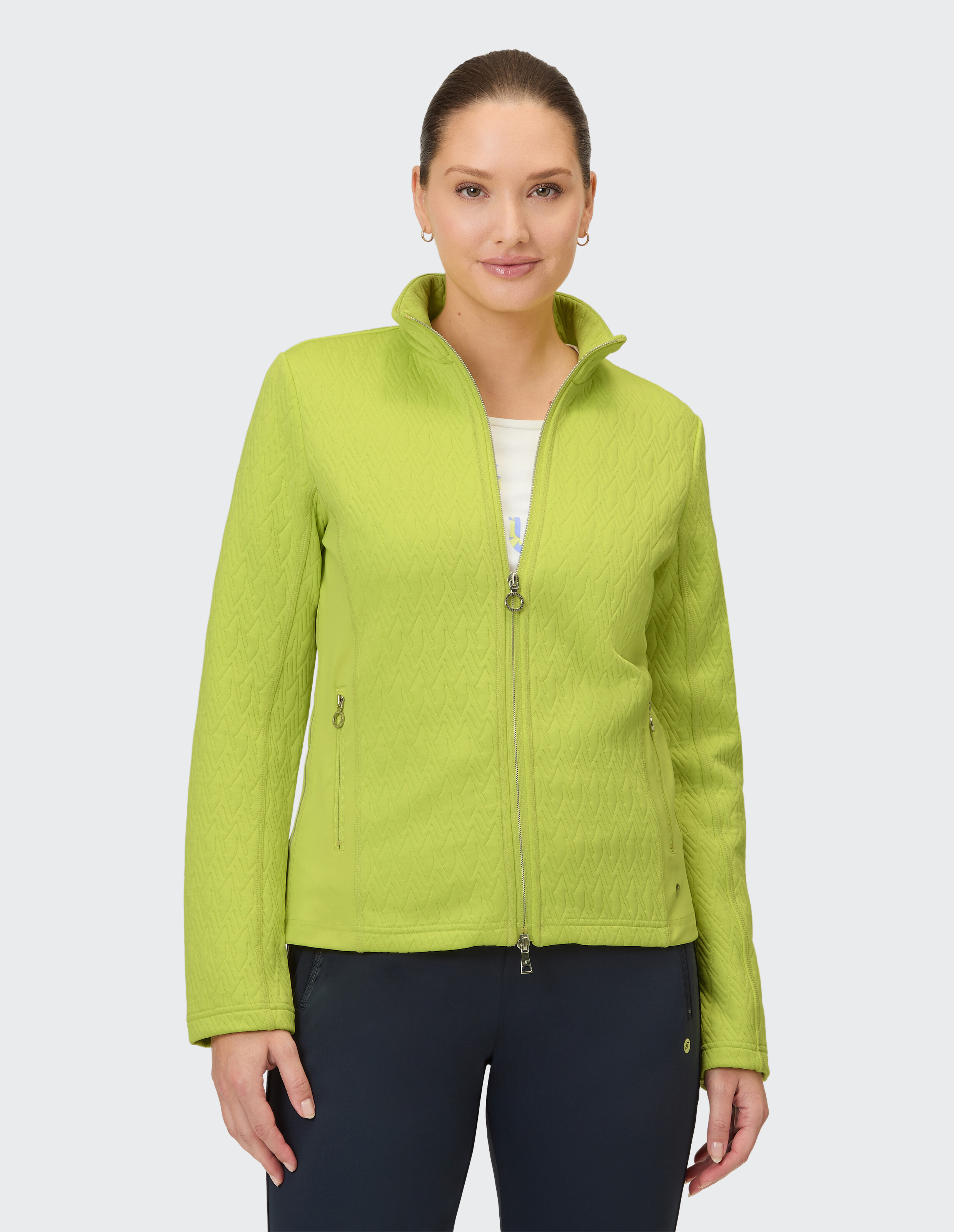 Eine leuchtend grüne Steppjacke mit durchgehendem Reißverschluss und Raunenmuster.