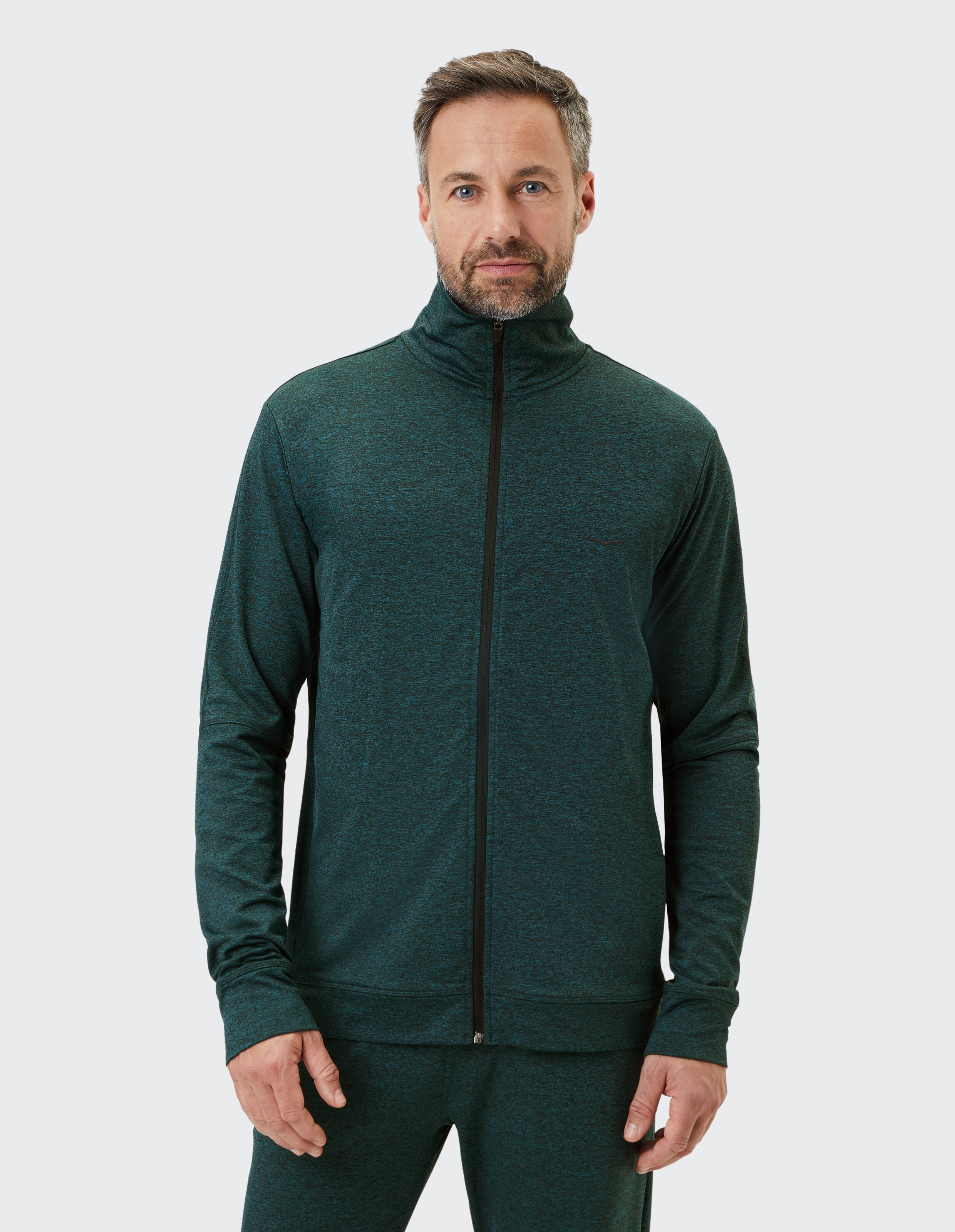 Mann trägt eine dunkelgrüne Clark-Reißverschlussjacke von Venice Beach Funktionsjacke.