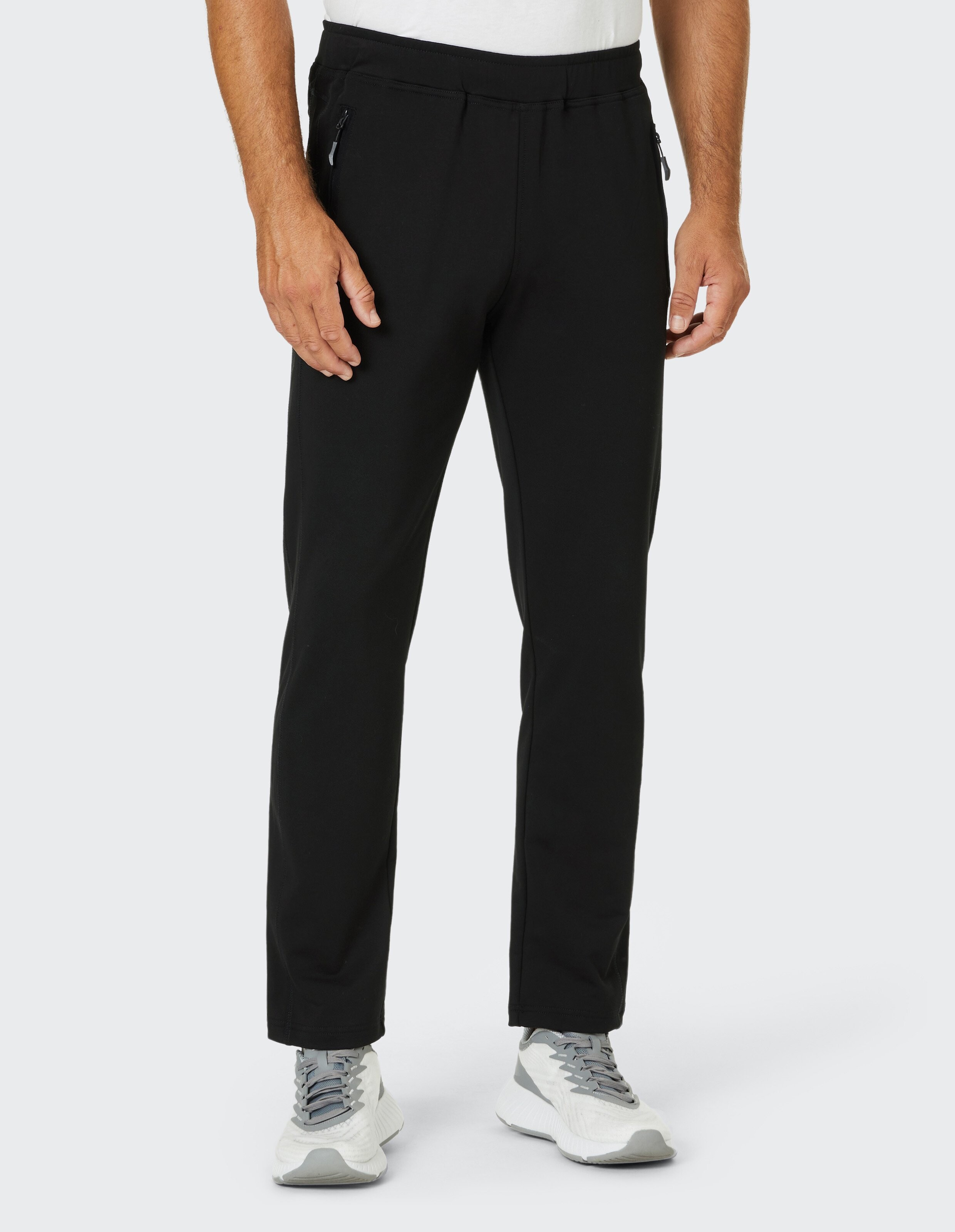 Schwarze Jogginghose mit elastischem Bund und Reißverschlusstaschen an den Seiten, schlichtes Design und bequemer Schnitt.